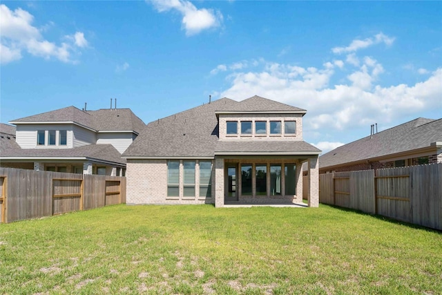 back of property featuring a lawn and a patio