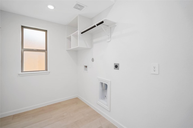 washroom with gas dryer hookup, hookup for an electric dryer, hookup for a washing machine, and light wood-type flooring