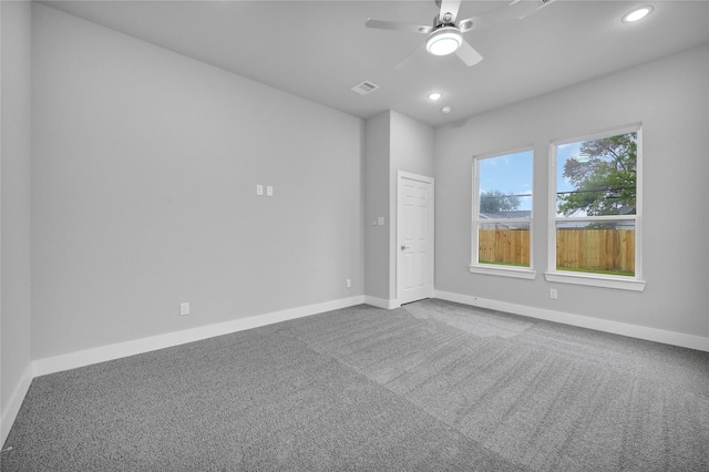 unfurnished room with carpet and ceiling fan