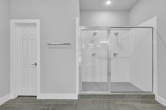 bathroom featuring a shower with door