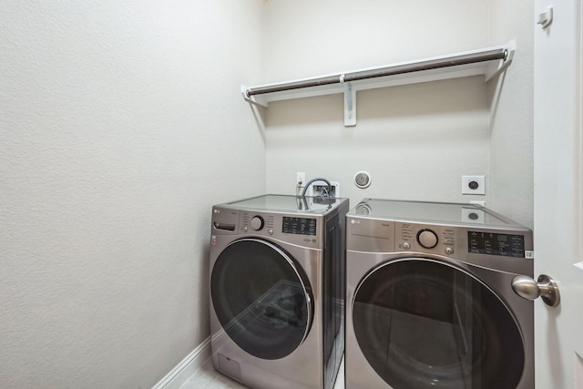 clothes washing area featuring washing machine and clothes dryer