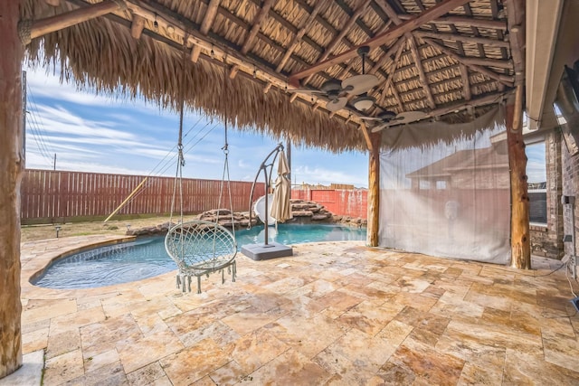 view of swimming pool with a patio, a gazebo, pool water feature, and ceiling fan