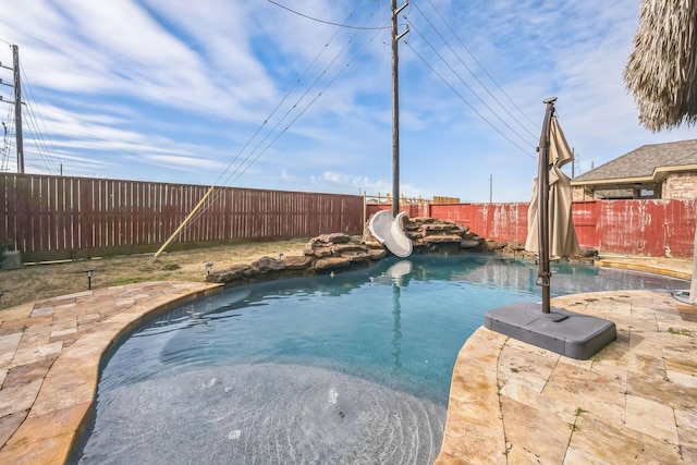 view of pool featuring a patio area and a water slide