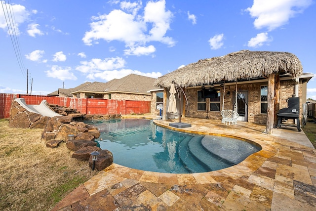 view of pool with pool water feature and a patio area