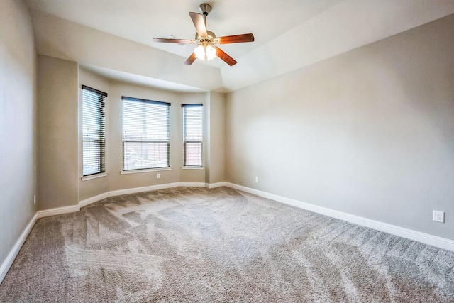 spare room with vaulted ceiling, carpet flooring, and ceiling fan