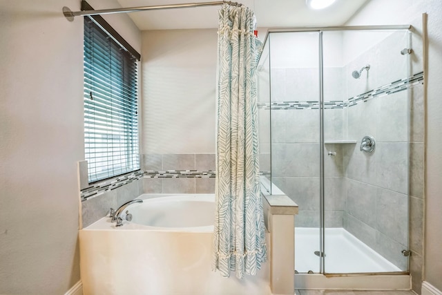 bathroom featuring shower with separate bathtub