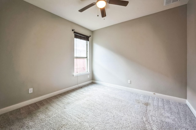 carpeted empty room featuring ceiling fan