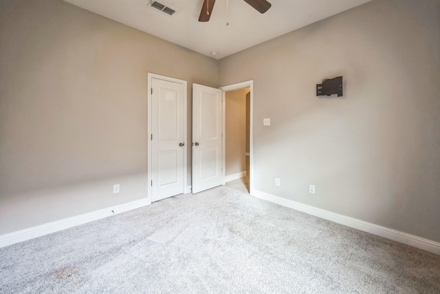 unfurnished bedroom featuring light colored carpet and ceiling fan