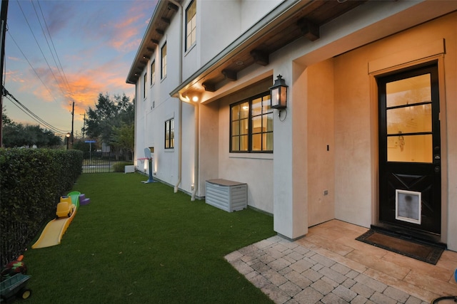 exterior space featuring a patio and a lawn