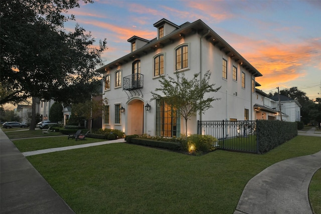 mediterranean / spanish-style house featuring a lawn