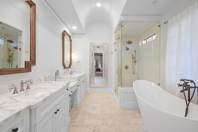 bathroom featuring vanity, lofted ceiling, and plus walk in shower