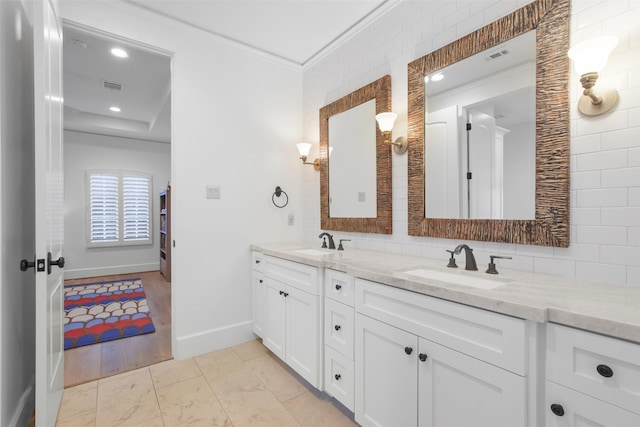 bathroom featuring vanity, decorative backsplash, and ornamental molding