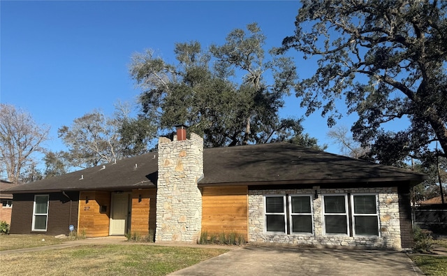 rear view of property featuring a lawn