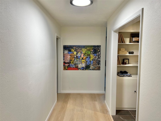 corridor with light hardwood / wood-style flooring