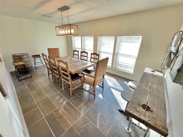 dining area with an inviting chandelier