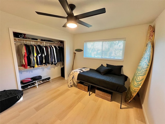 bedroom with hardwood / wood-style floors, a closet, and ceiling fan