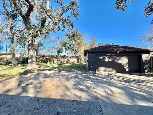 view of side of property featuring an outbuilding, a garage, and a yard