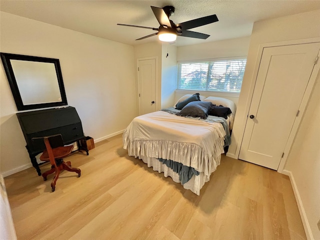 bedroom with light hardwood / wood-style flooring and ceiling fan