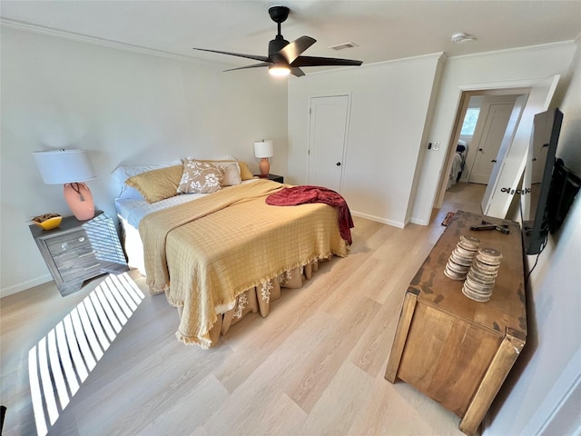 bedroom featuring light hardwood / wood-style flooring, ornamental molding, and ceiling fan