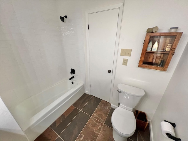 bathroom featuring washtub / shower combination and toilet