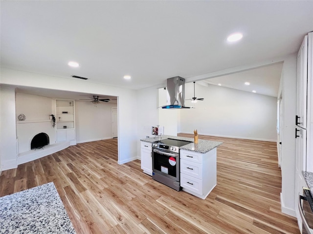 kitchen featuring extractor fan, light stone counters, stainless steel range with electric stovetop, ceiling fan, and white cabinets