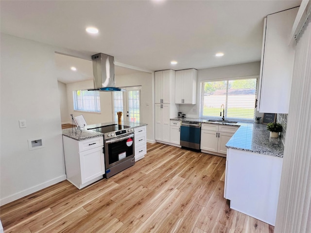 kitchen featuring island exhaust hood, appliances with stainless steel finishes, light stone countertops, and white cabinets