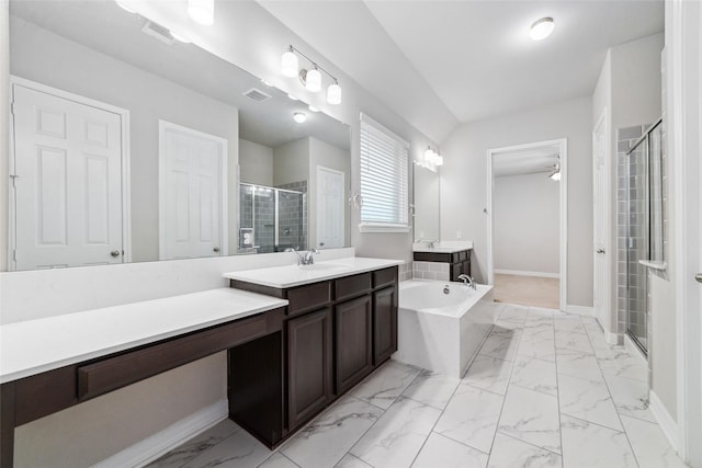 bathroom featuring vanity and independent shower and bath