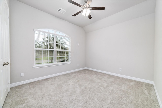 unfurnished room with lofted ceiling, light carpet, and ceiling fan