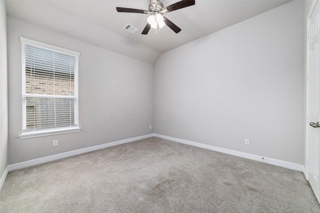 unfurnished room with ceiling fan, lofted ceiling, and carpet