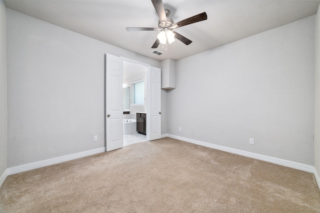 unfurnished bedroom featuring light colored carpet and ceiling fan