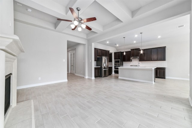 unfurnished living room featuring beamed ceiling, ceiling fan, coffered ceiling, and a fireplace