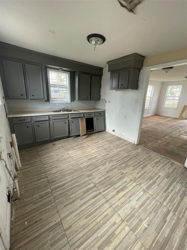 kitchen with gray cabinetry and sink