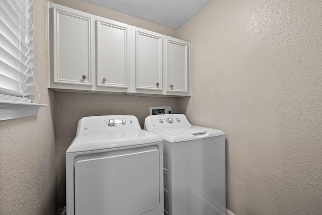 washroom with independent washer and dryer and cabinets