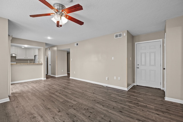 250 El Dorado Blvd Unit 127, Webster, TX 77598 - unfurnished living room featuring dark wood-style floors, a ceiling fan, baseboards, a textured ceiling, and recessed lighting