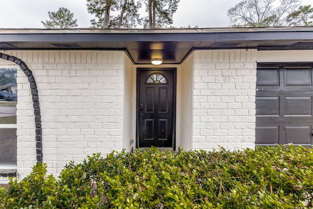 doorway to property featuring a garage