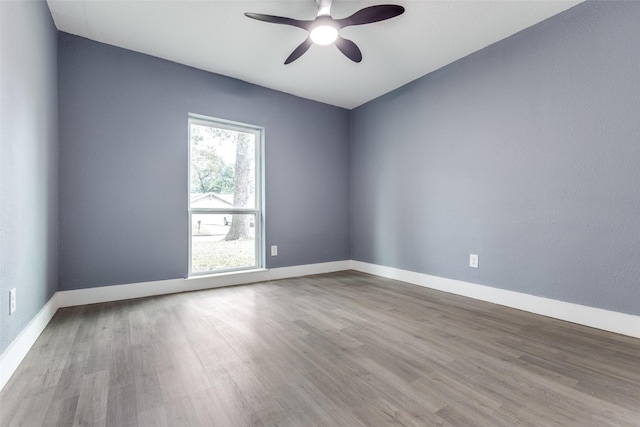 empty room featuring hardwood / wood-style flooring and ceiling fan