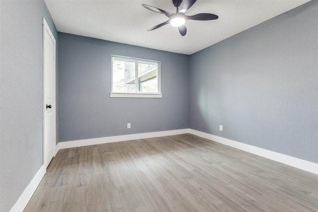 empty room with light hardwood / wood-style flooring and ceiling fan