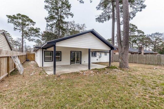 rear view of house with a yard and a patio