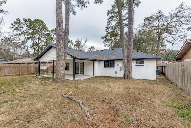 rear view of house featuring cooling unit, a yard, and a patio area