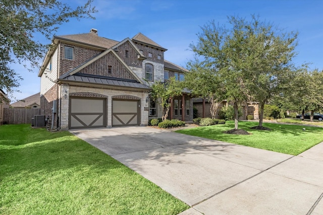 view of front of property with cooling unit, a garage, and a front yard