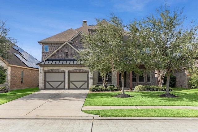 view of front of home with a garage and a front yard