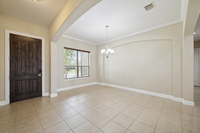 foyer with ornamental molding, light tile patterned floors, and a notable chandelier