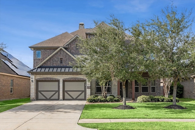 view of front of home featuring a garage and a front yard