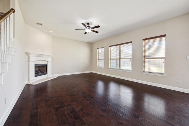 unfurnished living room featuring dark hardwood / wood-style floors and ceiling fan