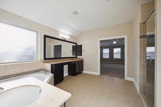 bathroom featuring vanity, lofted ceiling, tile patterned floors, and separate shower and tub