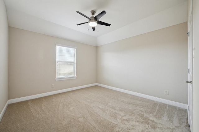 carpeted empty room featuring lofted ceiling and ceiling fan