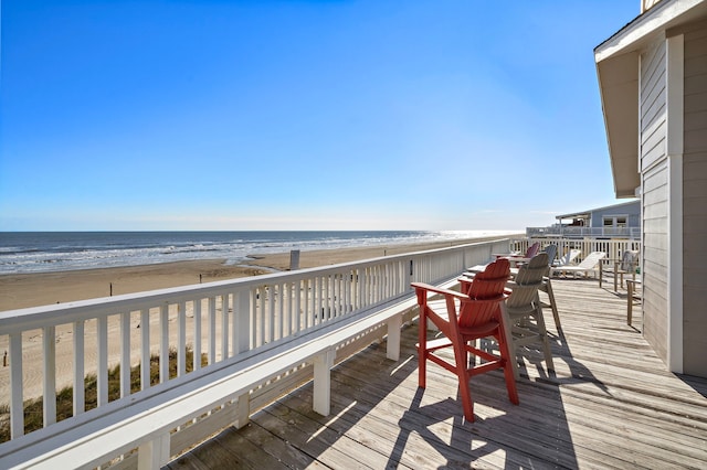 deck featuring a view of the beach and a water view