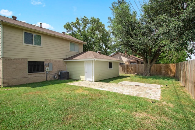 back of house featuring central AC, a patio, and a lawn