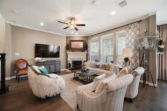 living room with ornamental molding, dark hardwood / wood-style floors, and ceiling fan