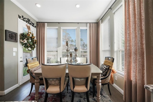 dining room featuring dark hardwood / wood-style flooring, ornamental molding, and a healthy amount of sunlight